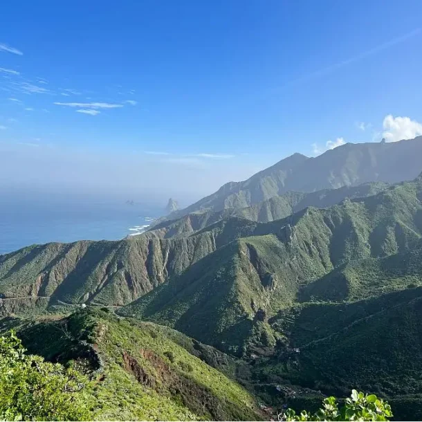 Tenerife, the largest of the Canary Islands, is renowned for its stunning landscapes, beautiful beaches, and vibrant culture. While most travelers flock to the southern part of the island to soak up the sun, there's a hidden gem in the north that often goes overlooked—the Anaga Mountains. As an SEO expert, I'm here to guide you through the wonders of the Anaga Rural Park and help you discover why it's a must-visit destination for nature enthusiasts and adventure seekers alike. The Anaga Mountains: A Natural Masterpiece 1. Breathtaking Scenery The Anaga Mountains, situated on the northeastern tip of Tenerife, offer some of the most breathtaking and unspoiled scenery on the island. This rugged terrain is characterized by lush laurel forests, jagged peaks, deep valleys, and dramatic coastal cliffs. The evergreen forests of Anaga have earned it a place on UNESCO's World Heritage List, making it a paradise for photographers and hikers. 2. Hiking Heaven One of the best ways to experience the Anaga Mountains is through its extensive network of hiking trails. Whether you're an experienced hiker or just a casual nature lover, there's a trail for you. The "Sendero de los Sentidos" (Trail of the Senses) is a gentle walk suitable for all ages, while the "Pico del Inglés" trail offers a more challenging ascent to a panoramic viewpoint. Don't forget to pack comfortable hiking shoes, a water bottle, and your camera to capture the mesmerizing vistas. 3. Unique Flora and Fauna Anaga's biodiversity is astounding. The ancient laurel forests, known locally as "laurisilva," are home to an array of endemic plant and animal species. Birdwatchers will be delighted by the chance to spot the endangered laurel pigeon and the rare Bolle's pigeon. Keep an eye out for Tenerife lizards and colorful butterflies as you explore the forested trails. Practical Tips for Visiting Anaga 1. Getting There The easiest way to reach the Anaga Mountains is by car. If you're staying in the southern part of Tenerife, expect a scenic drive of approximately 1.5 to 2 hours. Alternatively, you can take a bus to Santa Cruz de Tenerife and then catch a local bus to Anaga. Make sure to check the bus schedules in advance. 2. Weather Considerations Due to its elevation, the weather in Anaga can be quite different from the rest of the island. Be prepared for cooler temperatures and occasional rain, even if the sun is shining in the south. Dressing in layers and carrying rain gear is advisable. 3. Respect the Environment As a responsible traveler, it's essential to leave no trace while visiting the Anaga Mountains. Stay on designated trails, dispose of your trash properly, and avoid disturbing the local wildlife. By doing so, you help preserve this pristine natural wonder for generations to come. Conclusion The Anaga Mountains in Tenerife are a testament to the island's diverse and awe-inspiring landscapes. From challenging hikes to serene forest walks, this natural paradise offers something for everyone. So, whether you're an adventurer looking for a new challenge or a nature lover seeking tranquility, make sure to include the Anaga Mountains in your Tenerife itinerary. It's a destination that promises unforgettable experiences and memories that will last a lifetime.