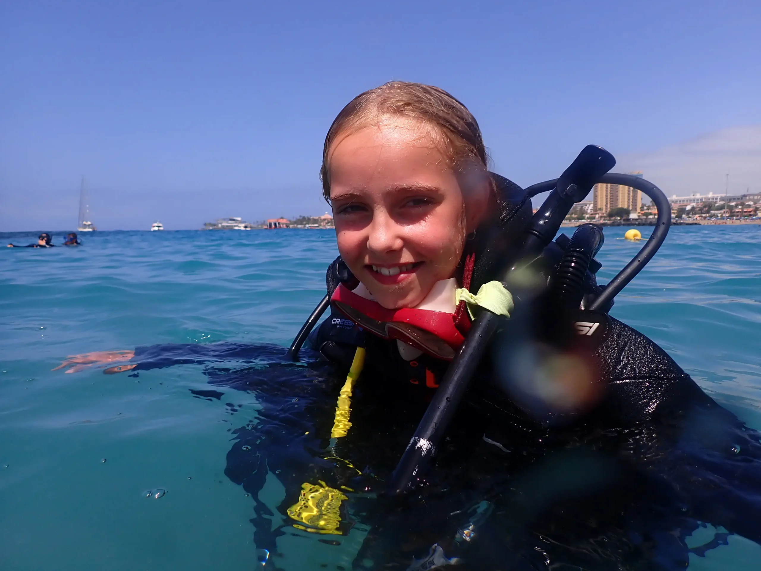 Discover Scuba Diving participant smiling at the surface during a first scuba experience